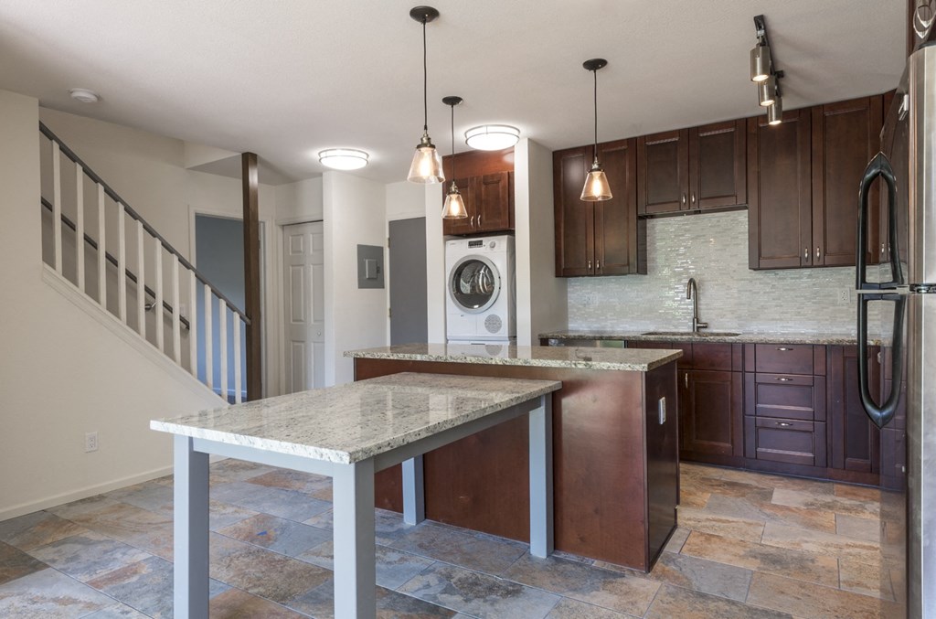 a kitchen with an island and a washing machine