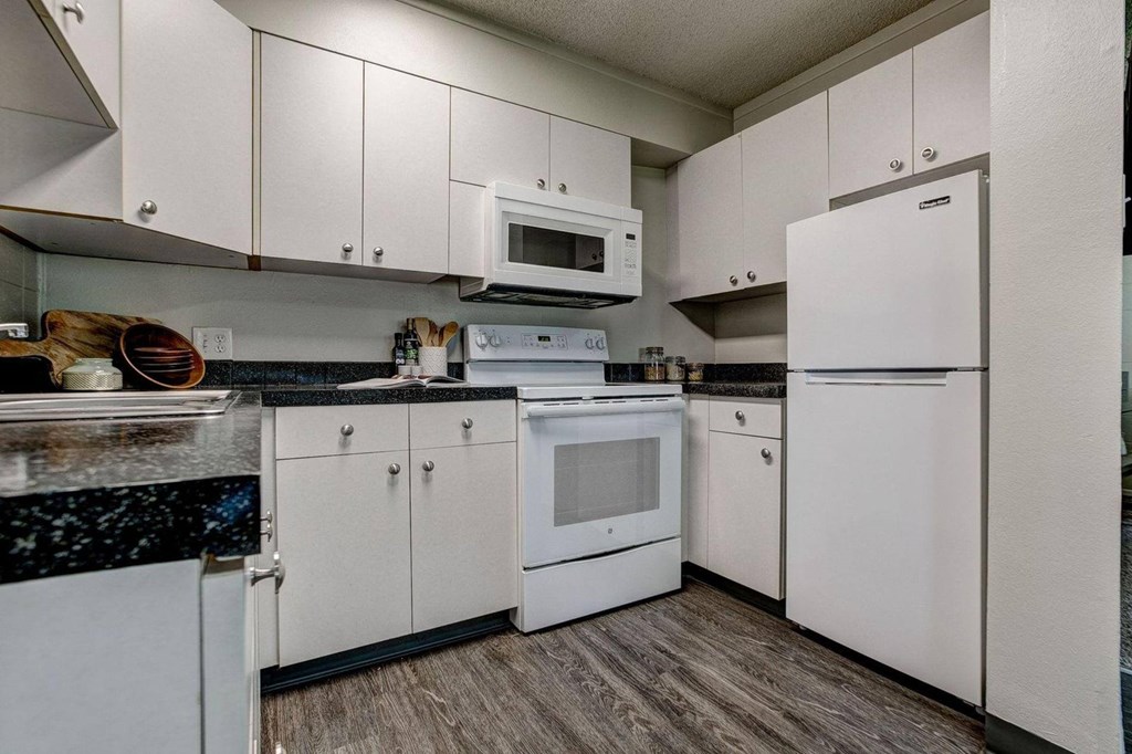 a kitchen with white appliances and white cabinets