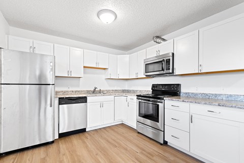 Kitchen with white cabinets and stainless steel appliances