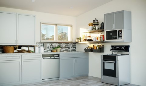 A modern kitchen with white cabinets and stainless steel appliances.