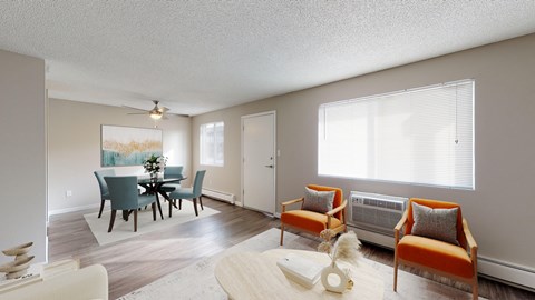 A living room with a dining table and chairs.
