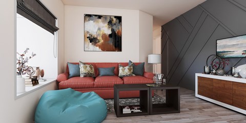 A living room with a red couch and a large abstract painting on the wall.