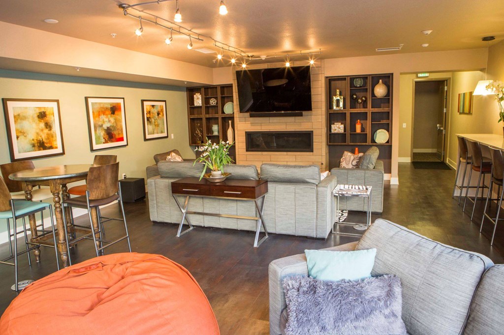 a living room with couches and a table and a television