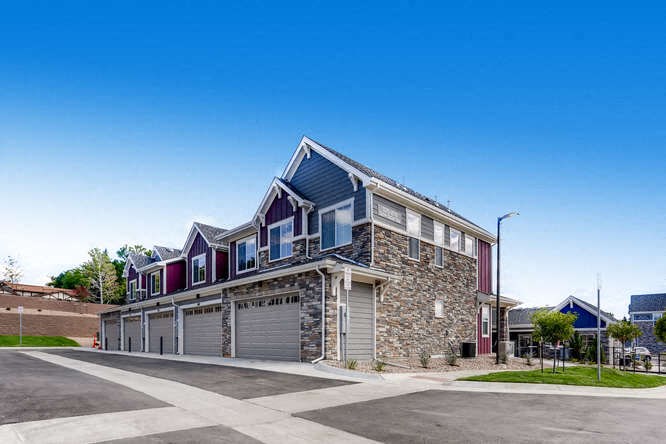 a brick house with a garage on a street