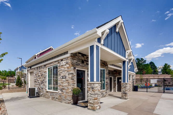 a building with a blue and white facade and a driveway