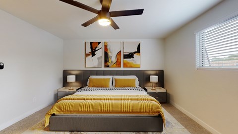 A bedroom with a bed, two lamps, and a ceiling fan.