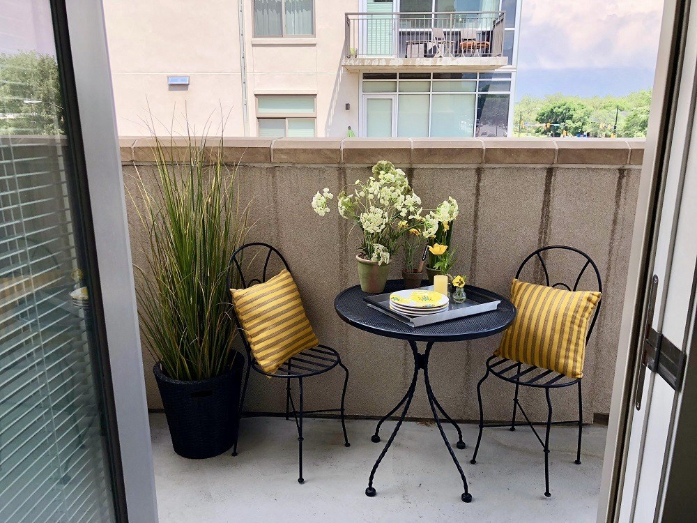 a small patio with a table and two chairs