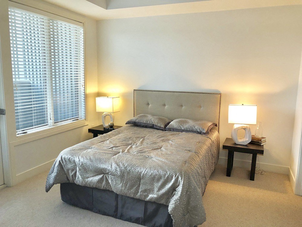 a bedroom with a bed and two night stands