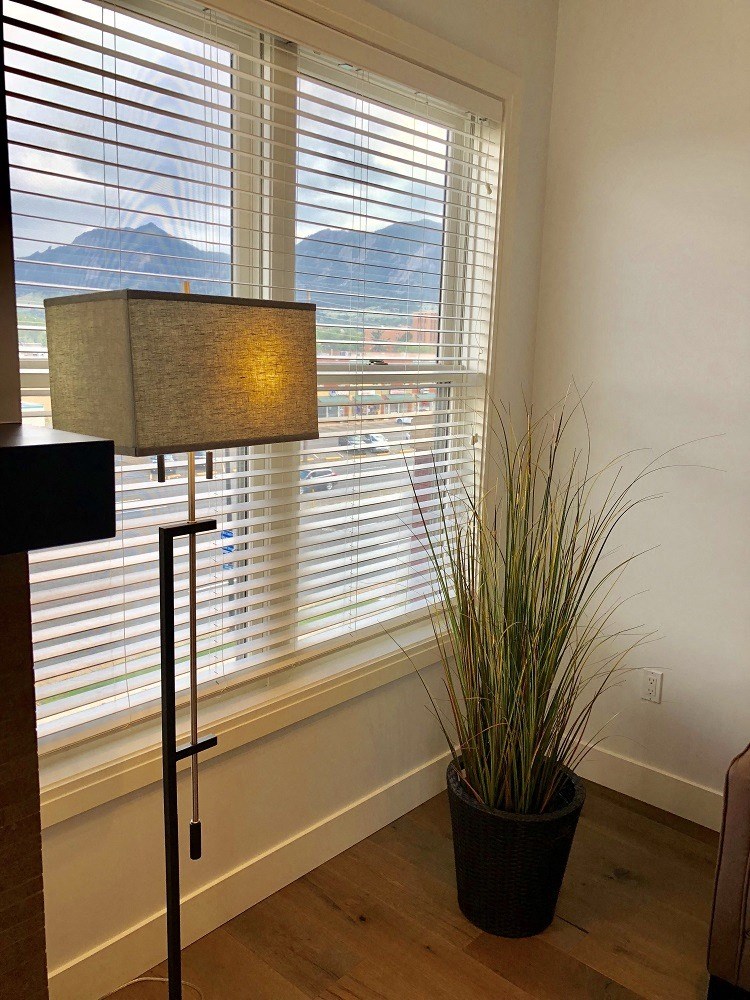 a large window with blinds in a living room