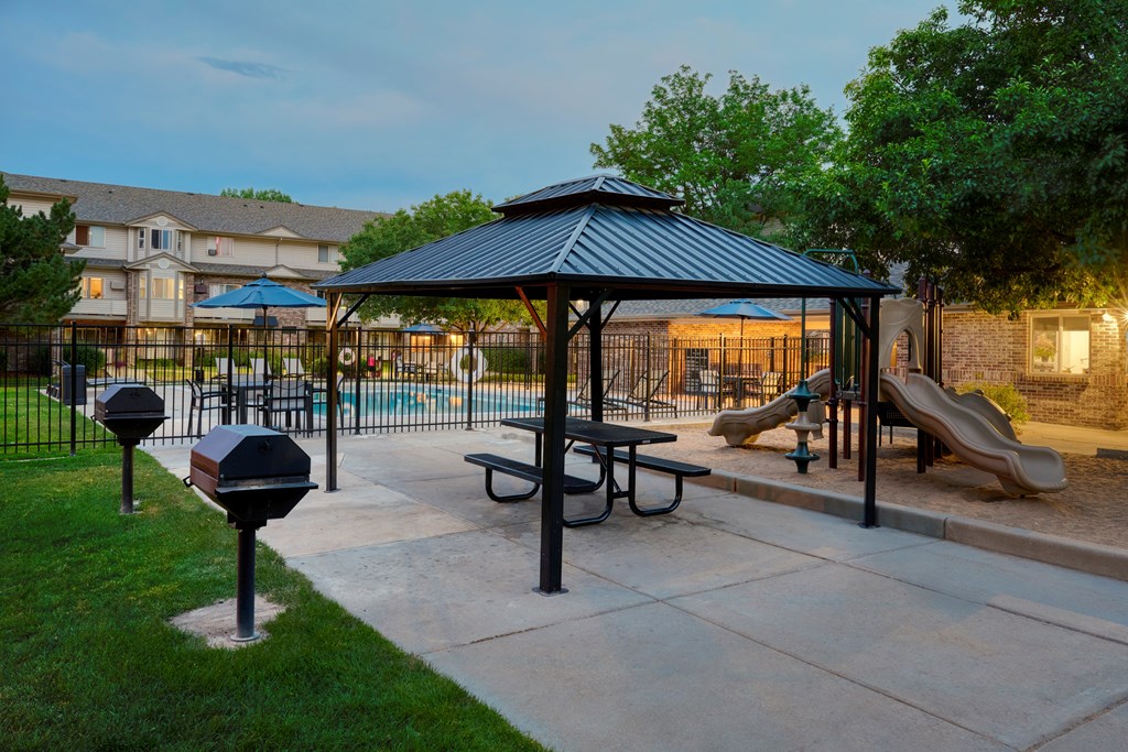 A playground with a swing set and a slide.