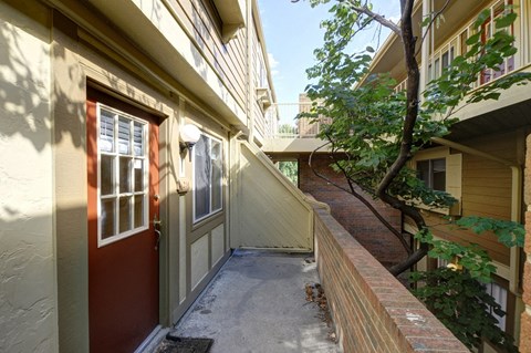 the front door of a house with a walkway next to it