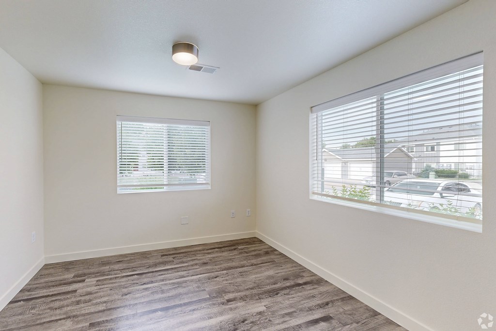 A room with a window and a ceiling fan.