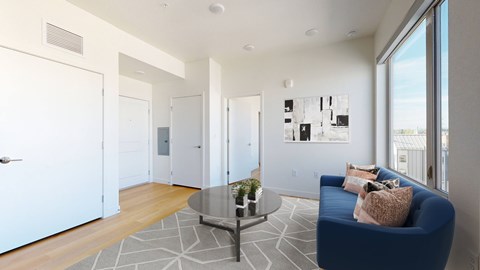 A living room with a blue couch and a coffee table.