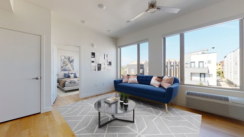 A living room with a blue couch and a coffee table.