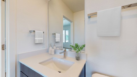 A bathroom with a sink and mirror.
