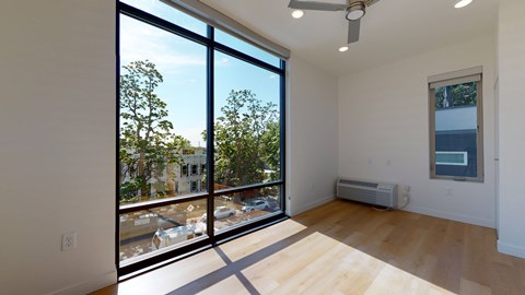 A room with a large window overlooking a parking lot.