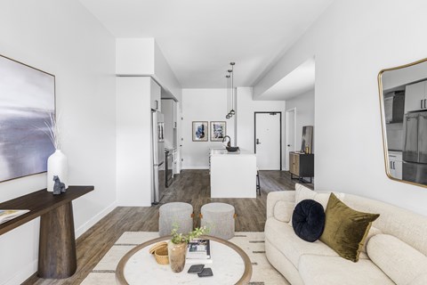 A modern living room with a white couch and a coffee table.