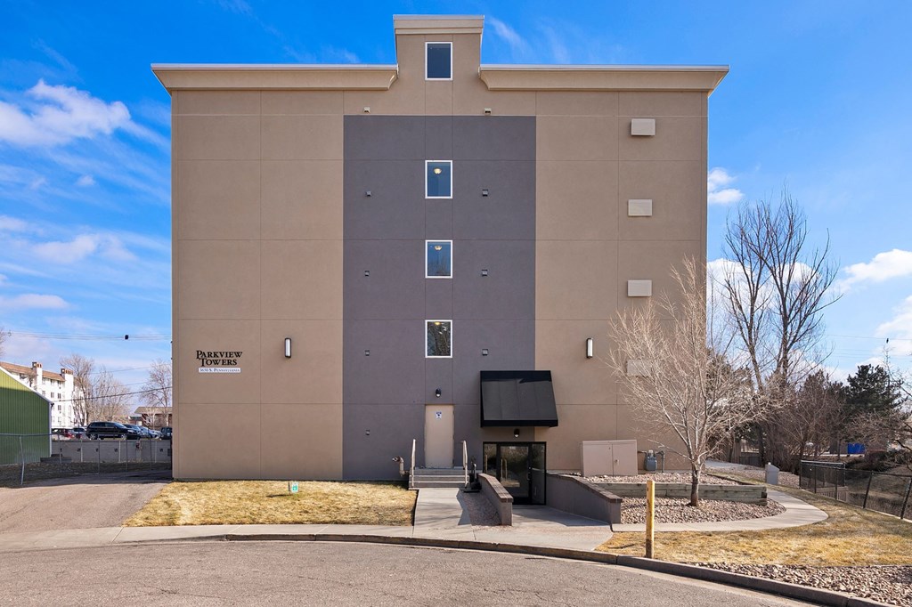 a brown building with a blue sky in the background