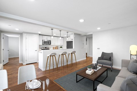 A modern living room with a dining table set for two.