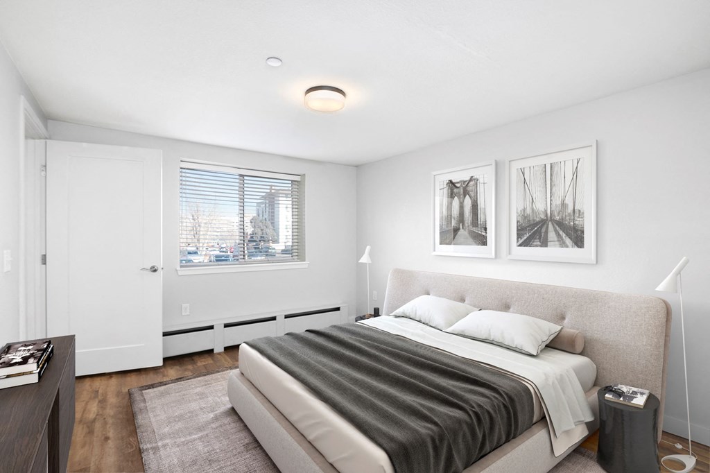 a bedroom with a bed and two windows