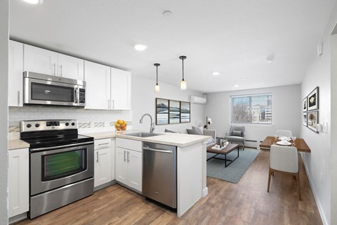 A modern kitchen with a stainless steel oven and microwave.
