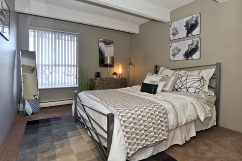a bedroom with a large bed and a window