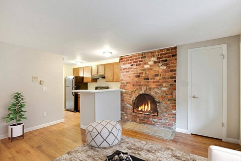 A living room with a fireplace and a white couch.
