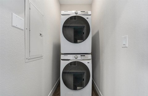 A white dryer and washer in a small laundry room.