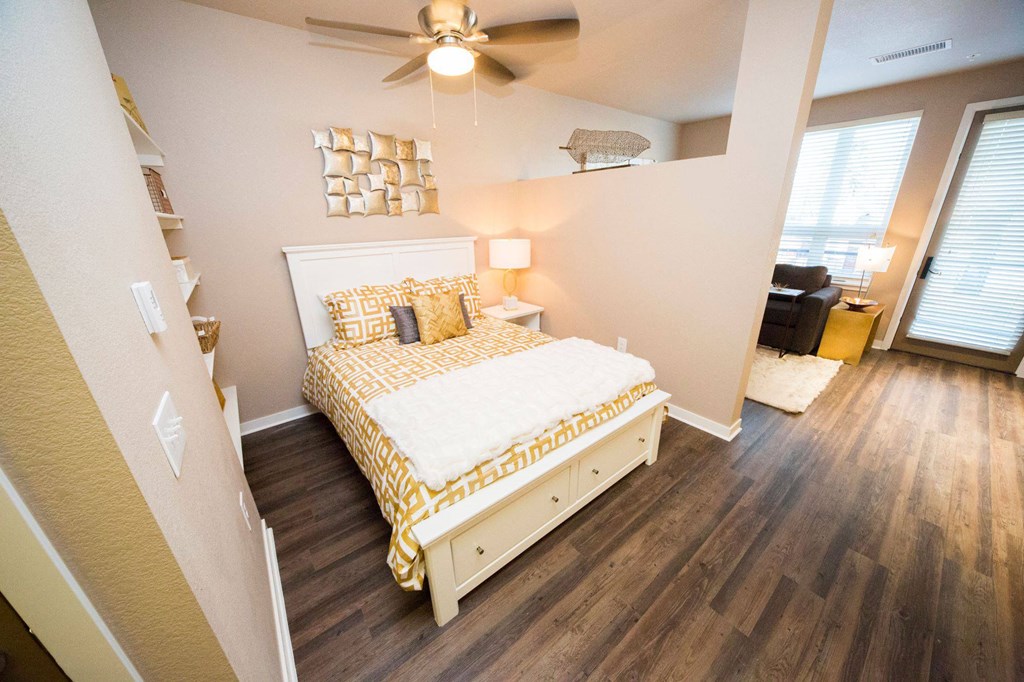 a bedroom with a bed and a ceiling fan