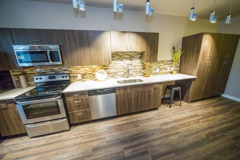 a kitchen with stainless steel appliances and wooden cabinets