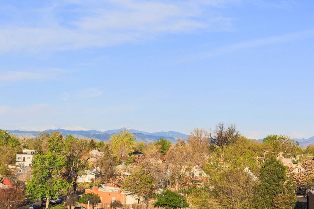 the view of the city and mountains from the roof of a house