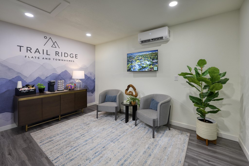 A waiting room with chairs and a television.