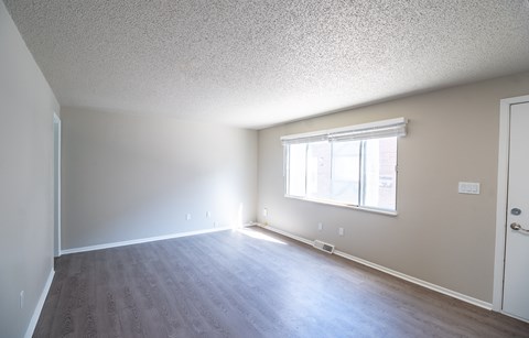 A room with a window and a door.