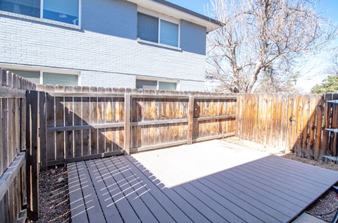 A wooden deck in front of a house.