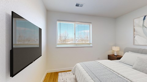 A bedroom with a large bed and a painting on the wall.