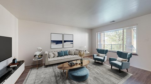 A living room with a grey sofa, a white side table, a wooden coffee table, and a blue chair.