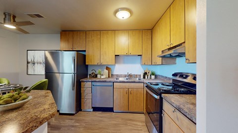 A kitchen with wooden cabinets and a stainless steel refrigerator.