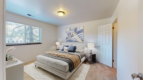 A bedroom with a bed, nightstands, and a painting on the wall.