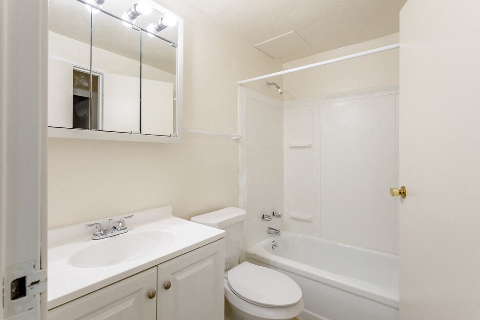 a bathroom with a sink toilet and a tub