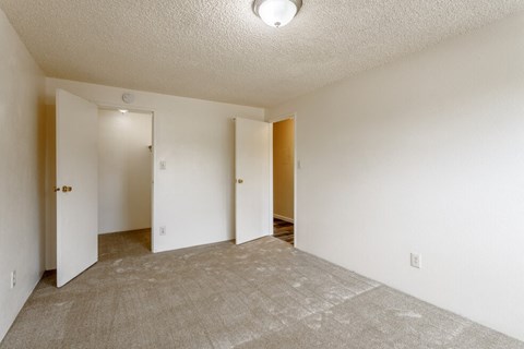 the spacious living room and dining room of an apartment
