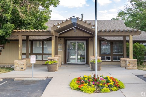 A building with a flower bed in front of it.