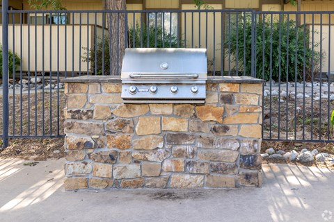A stone wall with a grill on top.
