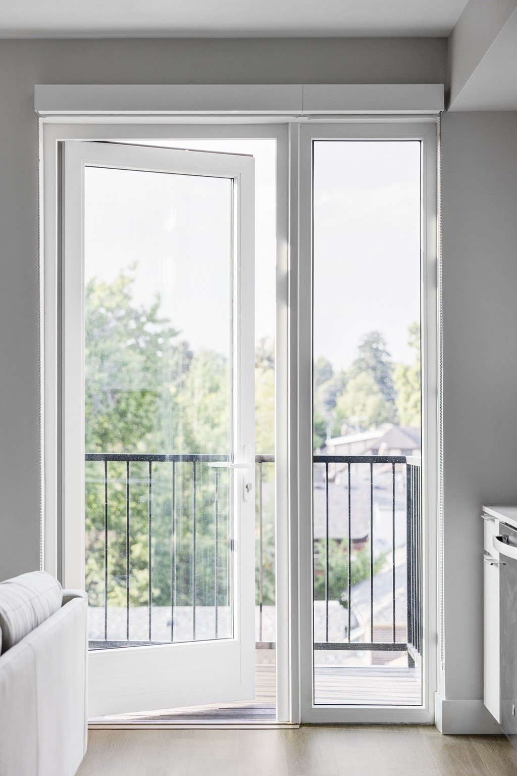 A white interior with a sliding glass door leading to a balcony.