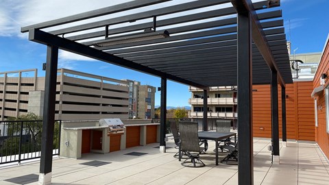 a patio with a table and chairs under awning