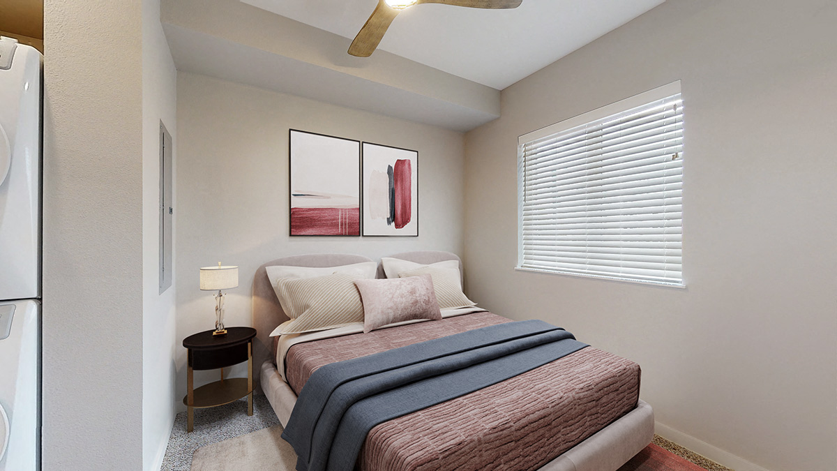 a bedroom with a bed and a window