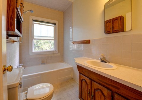 a bathroom with a sink toilet and a bath tub