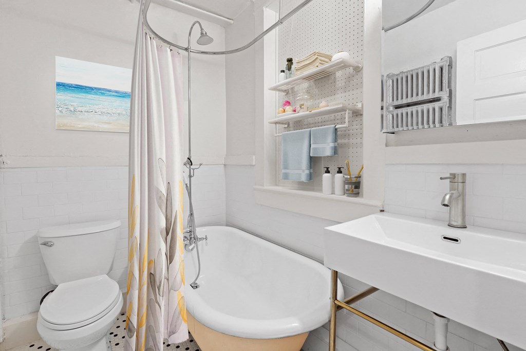 a bathroom with a shower and a sink and a toilet