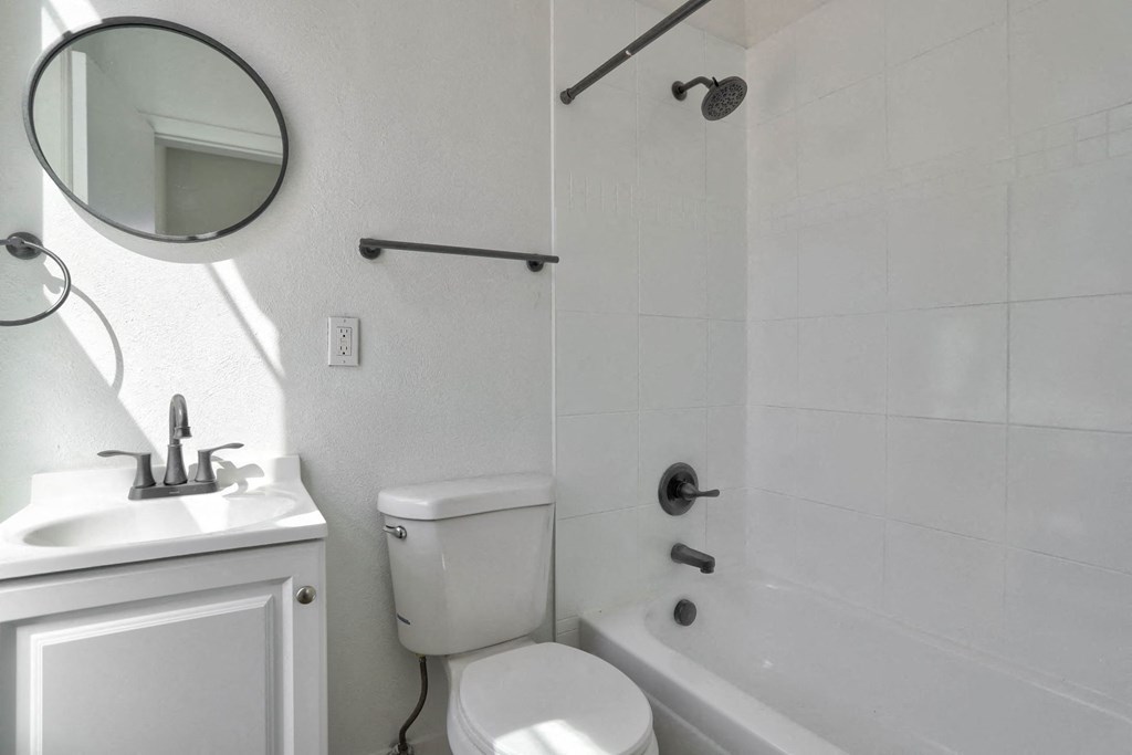 a bathroom with a sink toilet and a bath tub