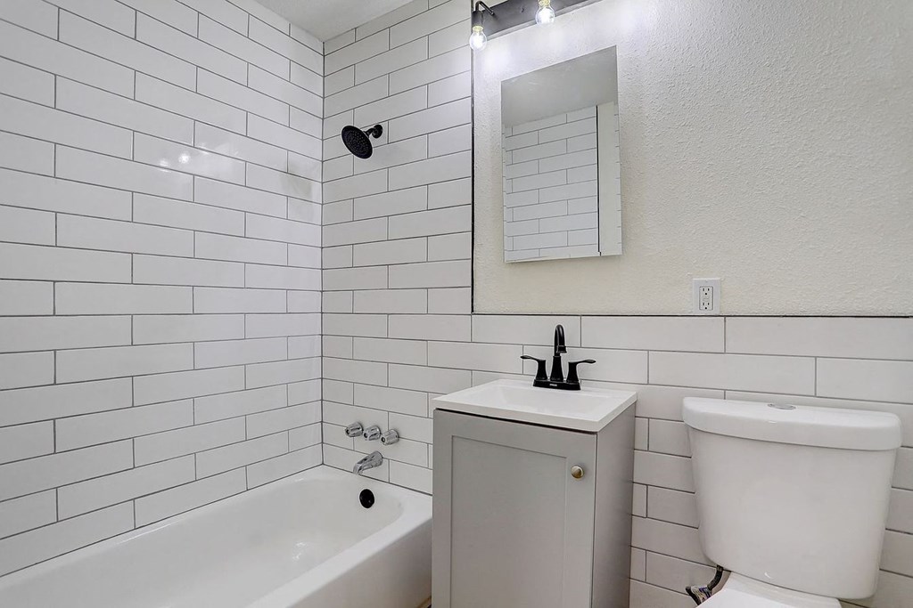 a white bathroom with a sink and a mirror