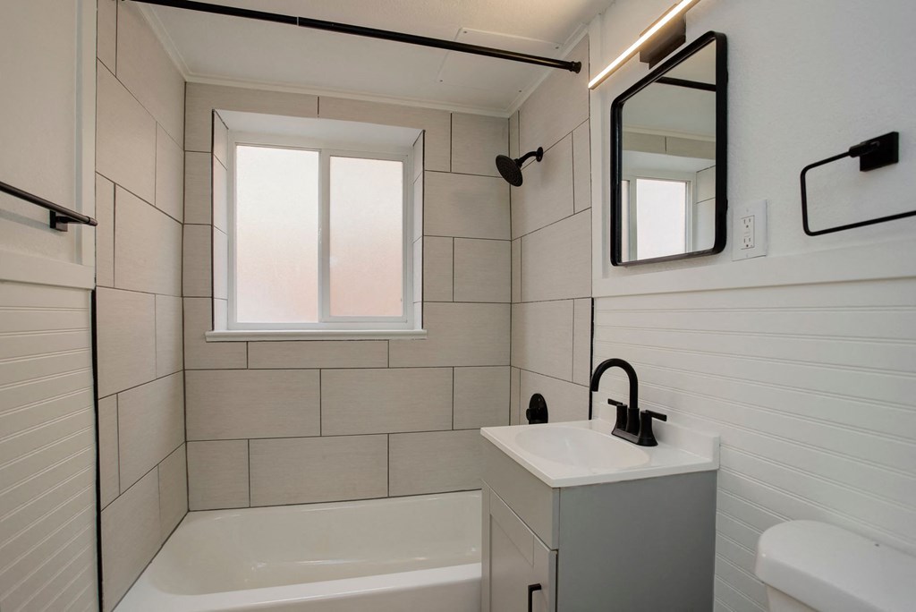 a small bathroom with a sink and a bath tub